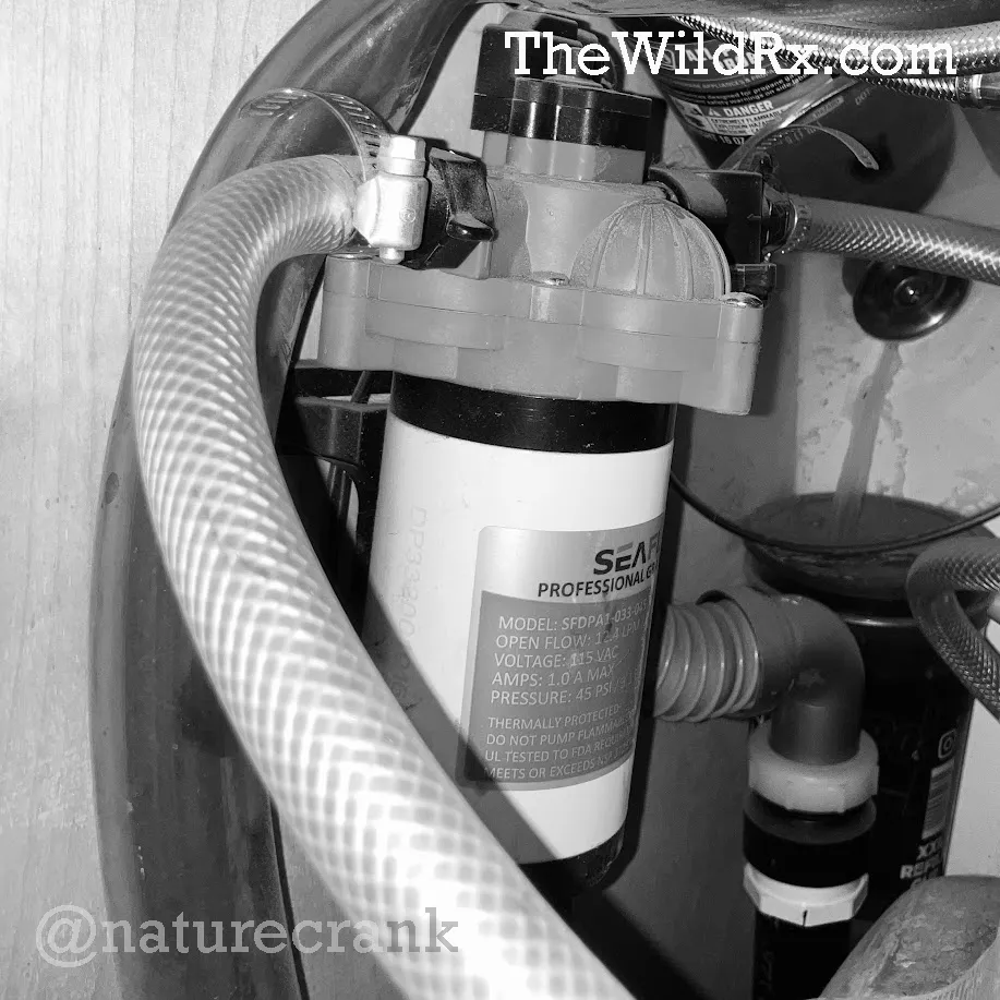 Close-up of a secondary water pump that connects to a Scepter military water jug inside an RV for winter boondocking