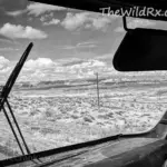 An RV parked on a dirt shoulder or roadside during an off-grid boondocking trip.