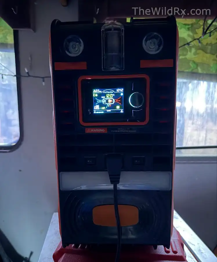 Interior view of a Vevor diesel heater installed in a campervan with custom 12V wiring and nylon fuel lines.