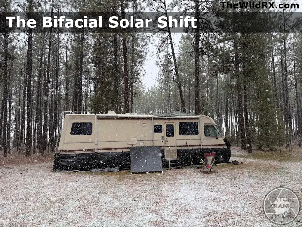 A bifacial solar panel set up in the snow next to an RV to demonstrate high albedo performance for a DIY solar system.