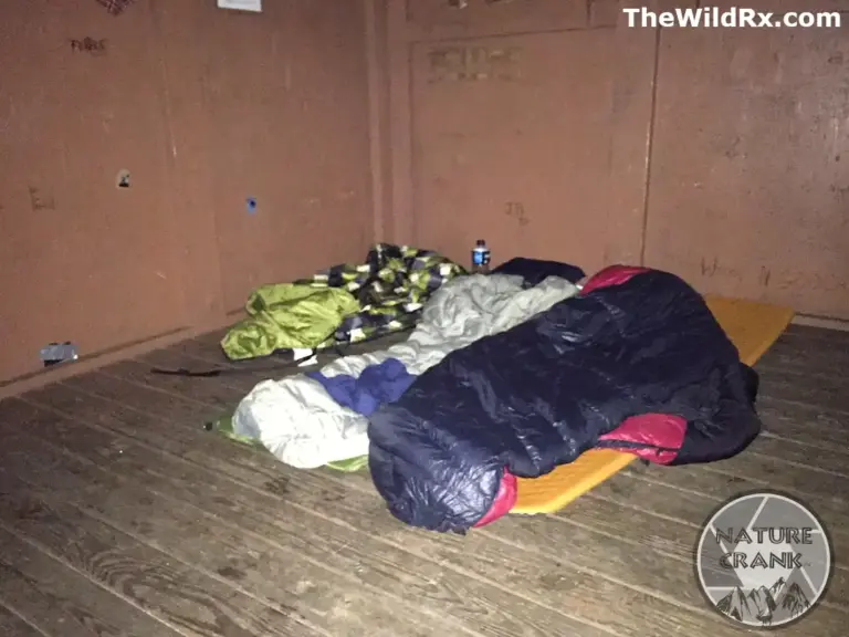sleeping bags on sleeping pads inside a wooden Appalachian Trail shelter during a thru-hike.